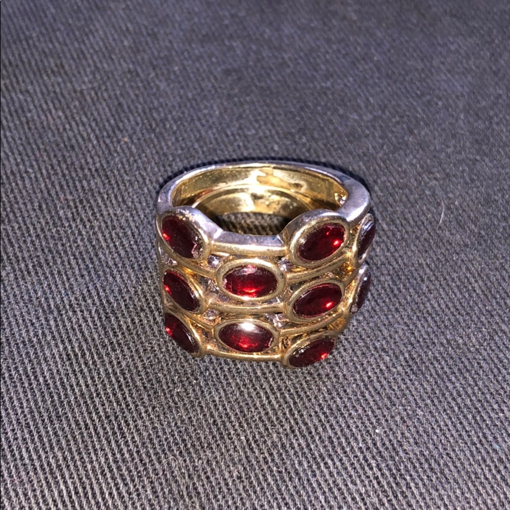 Gold tone ring with red stones.